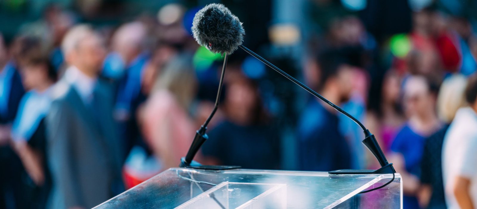 A podium and microphone set up before a speech to a crowd, representing recognition and celebration