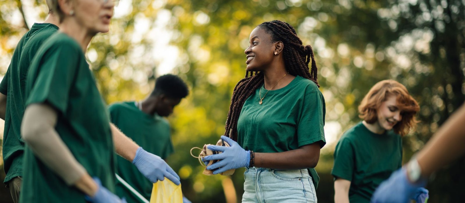 A group of volunteers collecting garbage together in a park