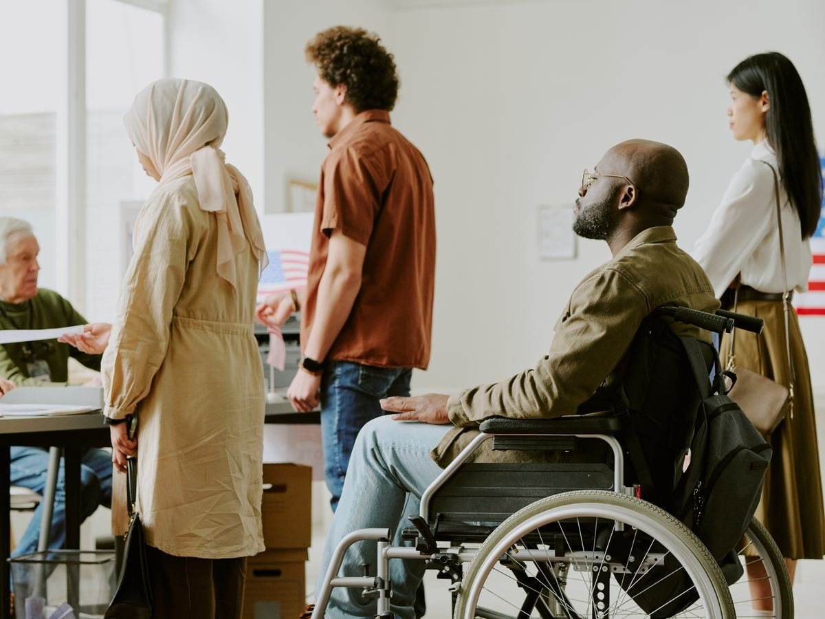 Diverse young people waiting in line at a polling station