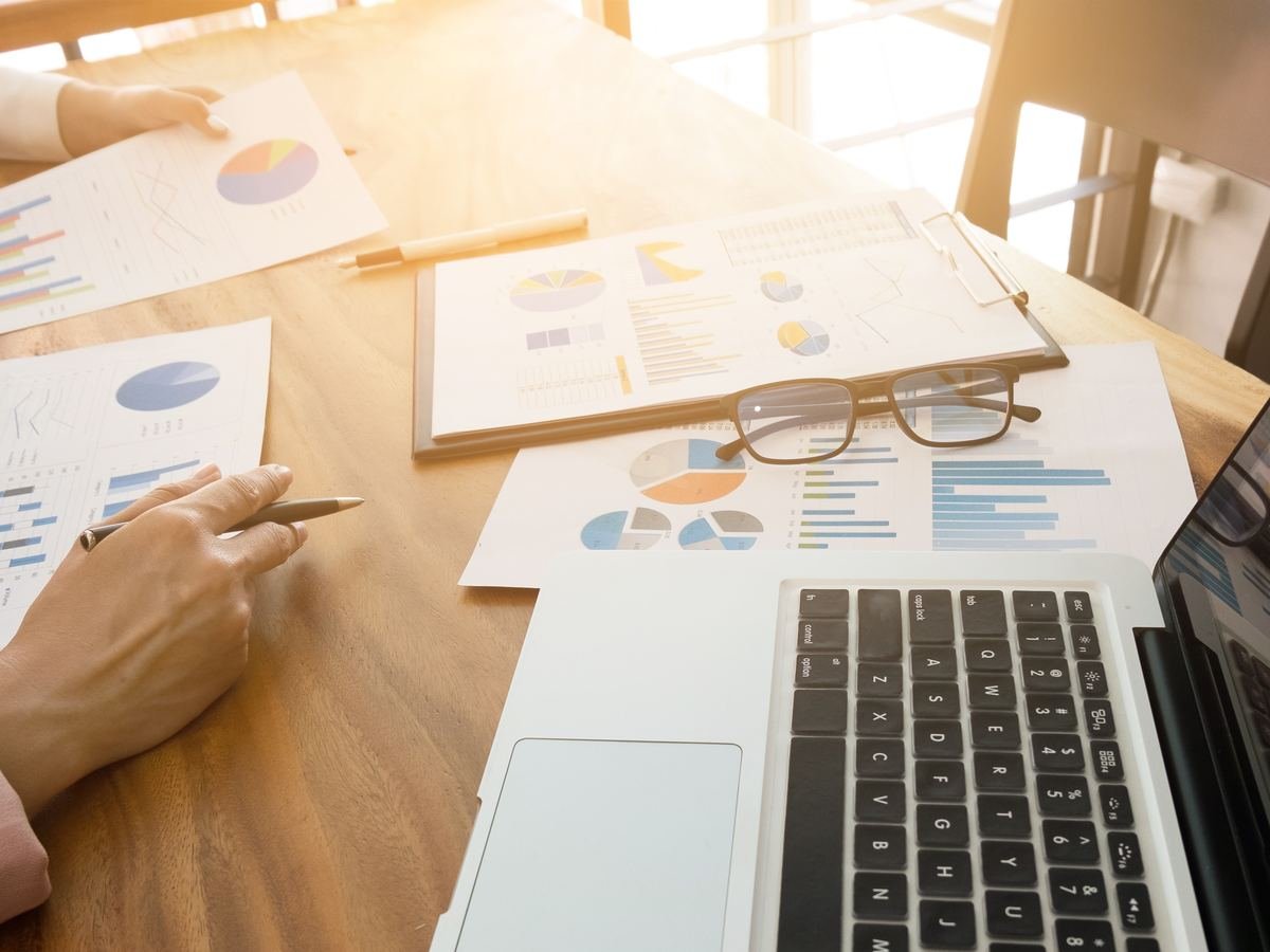 A researcher reviewing charts and graphs as part of policy analysis